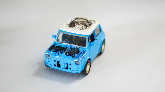 a miniature car that was scribbled on by a child