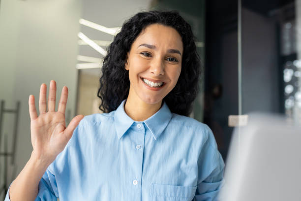 istock Young successful hispanic woman working inside office with laptop, waving at camera using video call, businesswoman talking with colleagues online remotely 1692476114