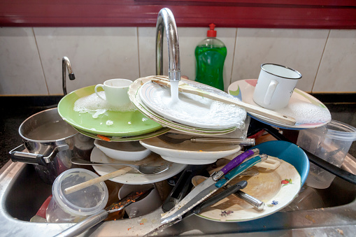 Pile of dirty dishes in domestic kitchen