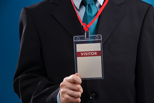 Stock image of name tag hung on human's neck.