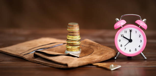 istock Coins with alarm clock, retirement savings and pension planning 1692483605