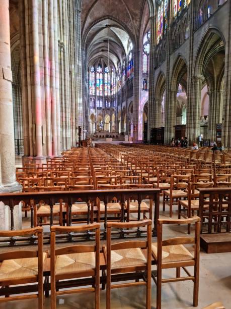 The Basilica of Saint-Denisis a large former medieval abbey church and present cathedral in the commune of Saint-Denis, a northern suburb of Paris. The church was completed in 1144 and widely considered the first structure to employ all of the elements of Gothic architecture. The image shows the interior of that magnificant cathedral.