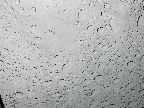 Raindrops on the glass of car in rainy weather