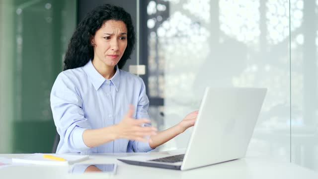 Frustrated female employee complains about poor performance of computer program on laptop