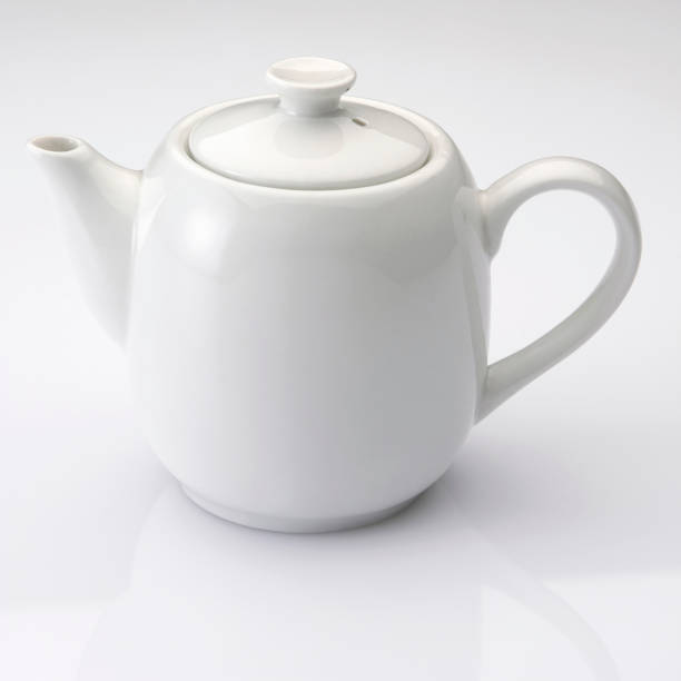 istock close up of the white teapot on plain background 1692492154