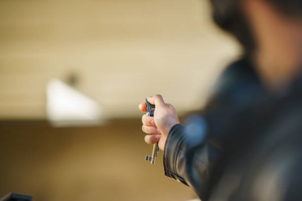 istock Young man closing the garage door with remote control key 1692492711