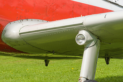 Bottom view of airplane at airport - Fuel inlet