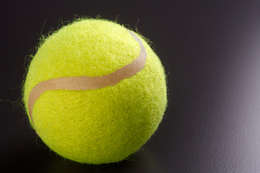 Tennis ball isolated on the black background.