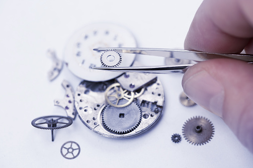 repairing old mechanical pocket watch.jpg