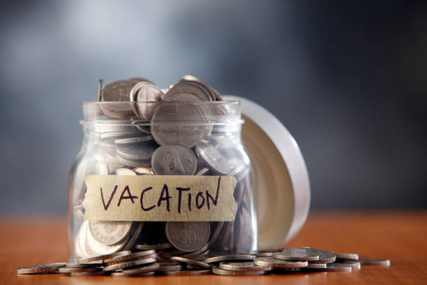 istock savings jar labeled vacation filled with money. 1692510406