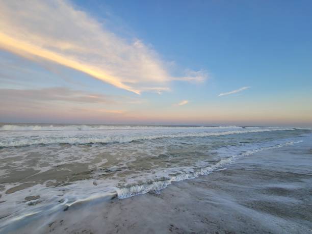 istock Sunset and cloud streaks over ocean 1692519202