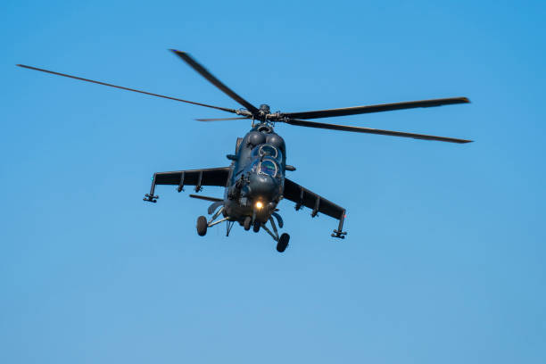 istock Soviet-made black Mi-24 military helicopter flying in the sky 1692520538