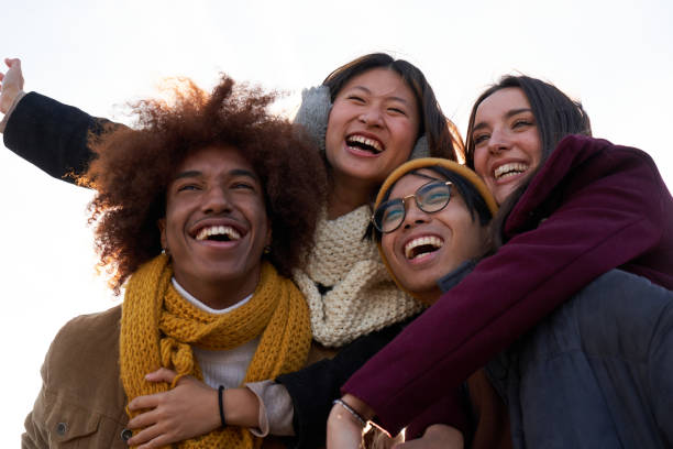 istock Group of multiethnic friends having fun outdoors, doing piggybacks and laughing together. 1692537358