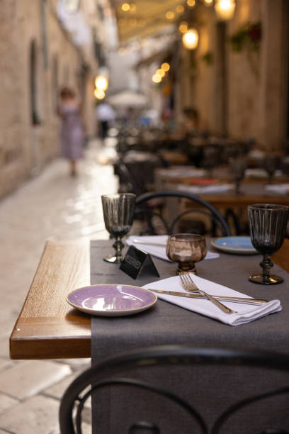 istock A table in a mediterranean restaurant set for dinner. Reserved marker on the table, shallow depth of field. Dubrovnik, Croatia 1692542082