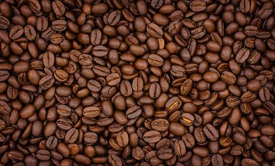 Roasted coffee beans background, close-up top view