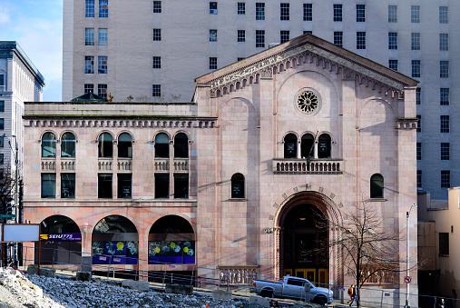 Seattle, King County, Washington state, United States: Seattle Metropolitan Chamber of Commerce - the largest business association in the region, represents the economic interests of its corporate members in the metro region of Seattle - Completed in 1924 to a design by Harlan Thomas, inspired in medieval Italian churches - the pedimented façade is divided into three parts enframed by pilasters; a central bay is flanked by blind arched bays to each side. The façade is capped by rake trim with gable end returns. A Lombardic-inspired frieze runs above a decorative blind arcaded corbel table, decorated with foliage patterns. The central entry bay of the façade includes a group of three arched windows  located above a raised frieze panel depicting ornate Romanesque arches within a blind arcade. A central rosette window is located within the central blind arch - Columbia