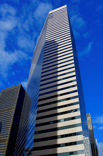Seattle, Washington state, United States: DocuSign Tower, formerly the Wells Fargo Center, originally the First Interstate Center - Construction was completed in 1983.  The six-sided tower designed by McKinley Architects in modernist and international styles has a steel frame and an exterior made of double glazing and granite. The skyscraper has a gold LEED certificate.