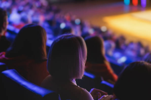istock Audience at the modern conference hall listens to panel discussion, people on a congress together listen to speaker on stage at convention, business seminar, amphitheater venue for congress 1692553167