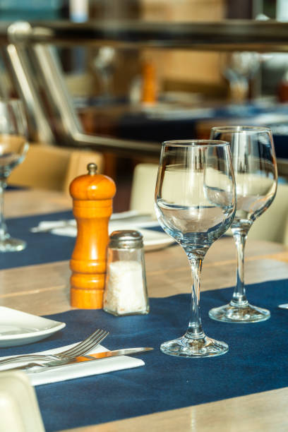 istock Closeup, two crystal glasses on the arranged table of a restaurant. 1692561247