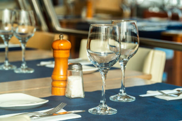 istock Closeup, two crystal glasses on the arranged table of a restaurant. 1692561257