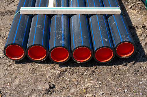 Six large water pipes in a stack.