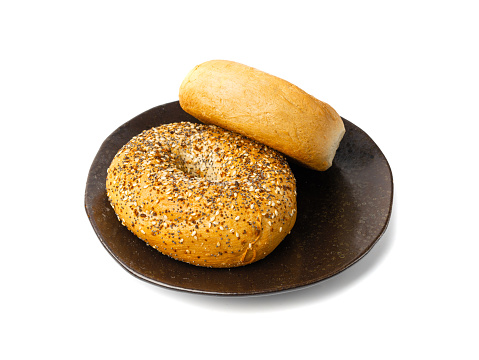 Bagel Isolated, Two Round Bread Buns, Wheat Bakery with Grains And Seeds for Breakfast, Plain Circle Bagels Bread on Black Plate on White Background