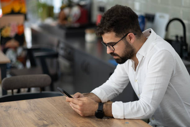 istock Artist young man wearing apron using phone 1692616241