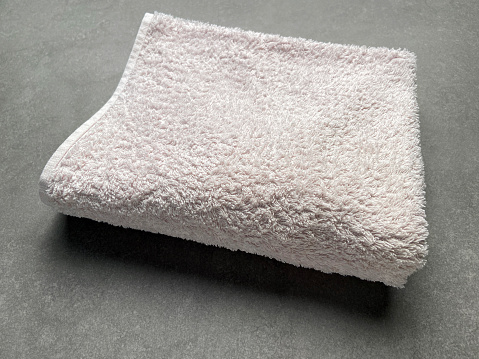 Folded cotton towel on granite tile