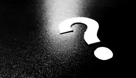 Question mark design made of paper on dark background