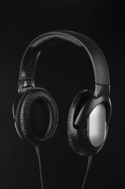 istock Headphones with cable close up on a black background 1692635436