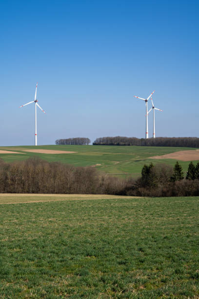 istock Landscape with grass, tress and wind turbines 1692643547