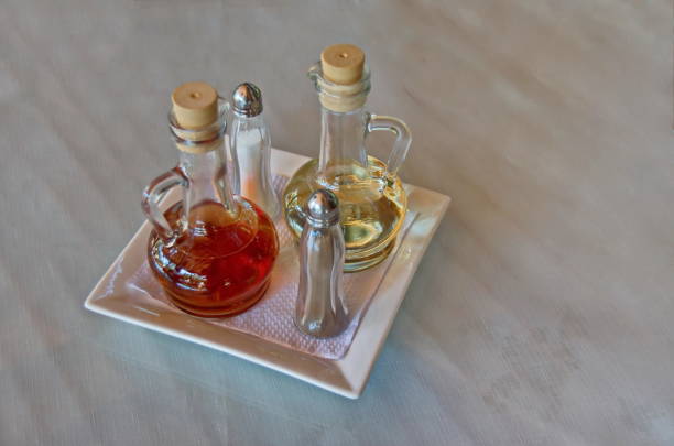 istock Glass condiment set with olive oil, vinegar, salt and pepper on kitchen table 1692659440