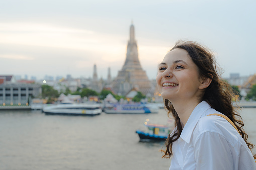 Young woman with traditional burmese holding bowl of rice on the hand at beautiful golden pagoda in Myanmar.