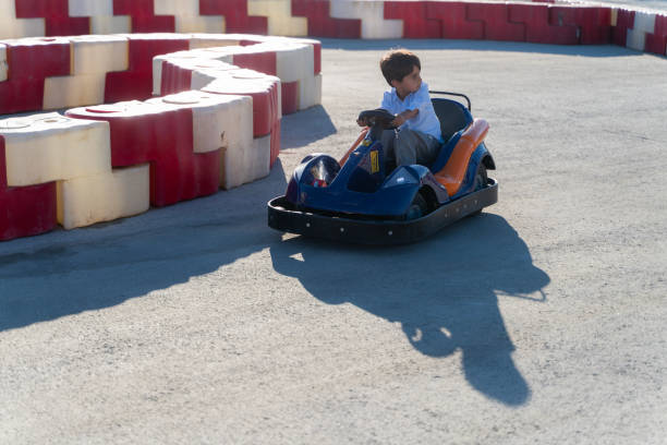 boy driving a battery-powered vehicle in a gokart