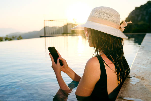 istock Woman using smart phone in the swimming pool 1692665066