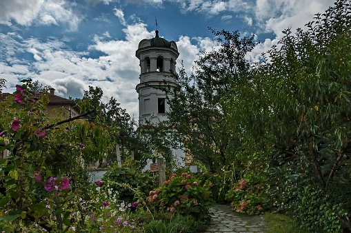 Berkovitsa, Bulgaria -  September 05, 2010: A view of the garden and bell tower in the Church of the Nativity of the Virgin Mary in the town of Berkovitsa, Bulgaria. Visit in place.