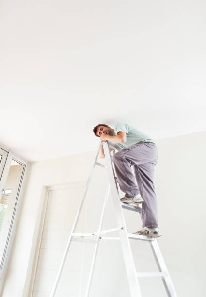 istock Man climbing ladder indoors 169270290