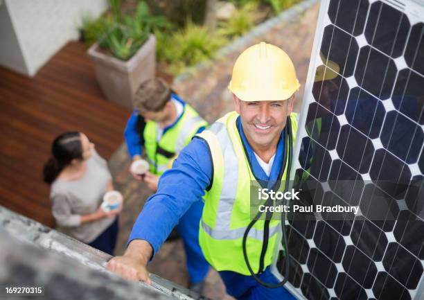 Worker Installing Solar Panel On Roof Stock Photo - Download Image Now - Solar Panel, Customer, Domestic Life