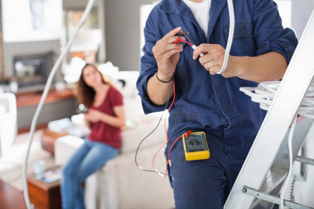 Electrician working in living room  electrician stock pictures, royalty-free photos & images