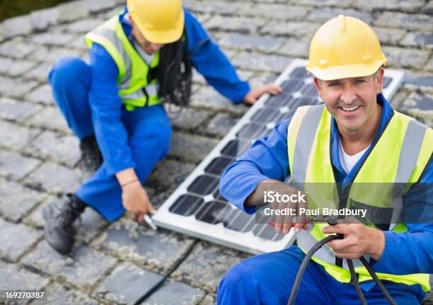 workers-installing-solar-panel-on-roof-stock-photo-download-image-now