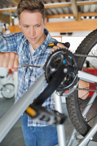 istock Man working on bicycle in shop 169270398