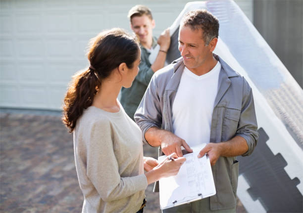 istock Woman signing for package in driveway 169270419