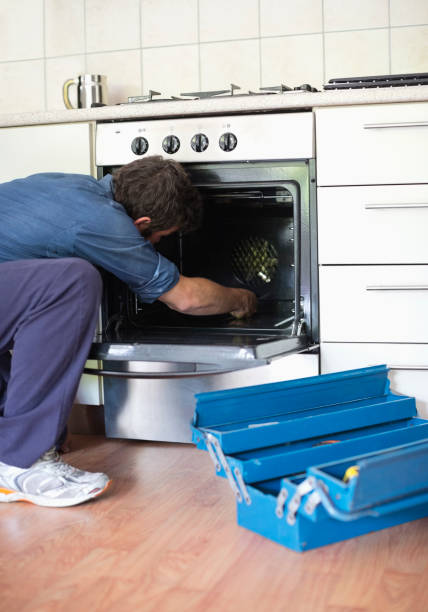 istock Electrician working on oven in kitchen 169270473