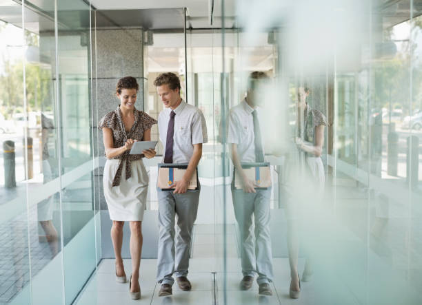 istock Business people talking in office hallway 169270559