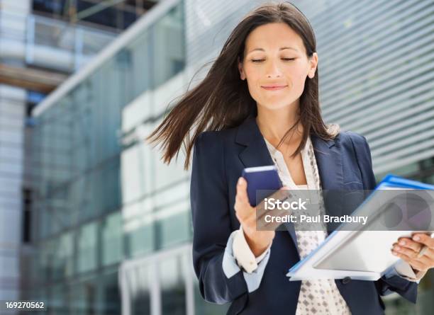 Businesswoman Using Cell Phone In Office Stock Photo - Download Image Now - Businesswoman, Mobile Phone, One Woman Only