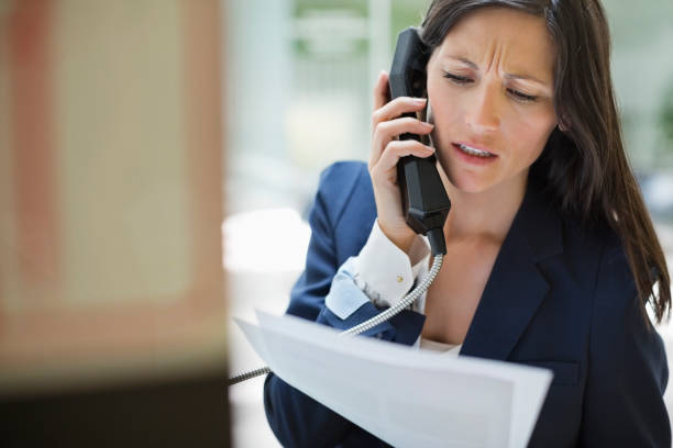 Businesswoman talking on phone in office  pay phone on the phone latin american and hispanic ethnicity talking stock pictures, royalty-free photos & images