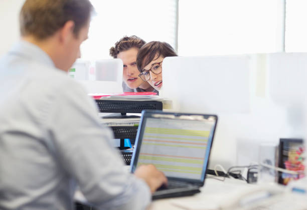 istock Business people eavesdropping on colleague 169270738