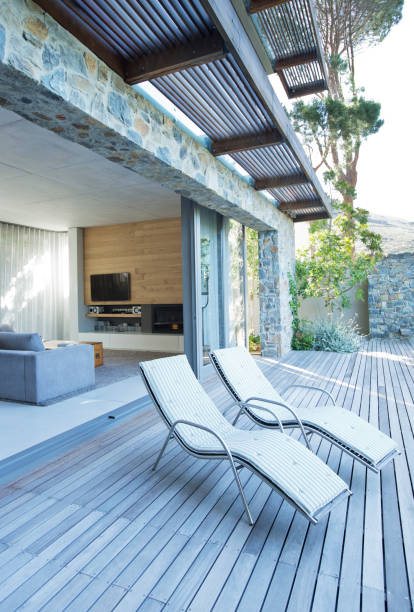 istock Lawn chairs on wooden patio 169271434