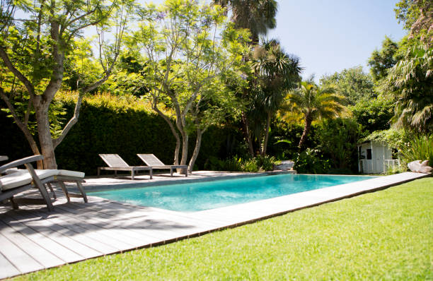 istock Lawn chairs and swimming pool in backyard 169271465