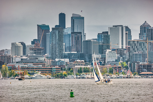 People sail on Lake Union in Seattle Washington USA on an overcast day.